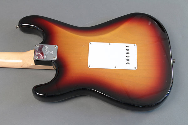 Back view of sunburst electric guitar with maple neck and white plastic back plate on gray background from Coffee House Guitars product listing