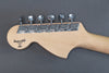 Close-up of maple wood electric guitar headstock with six chrome tuning pegs and Custom Shop USA logo on gray background