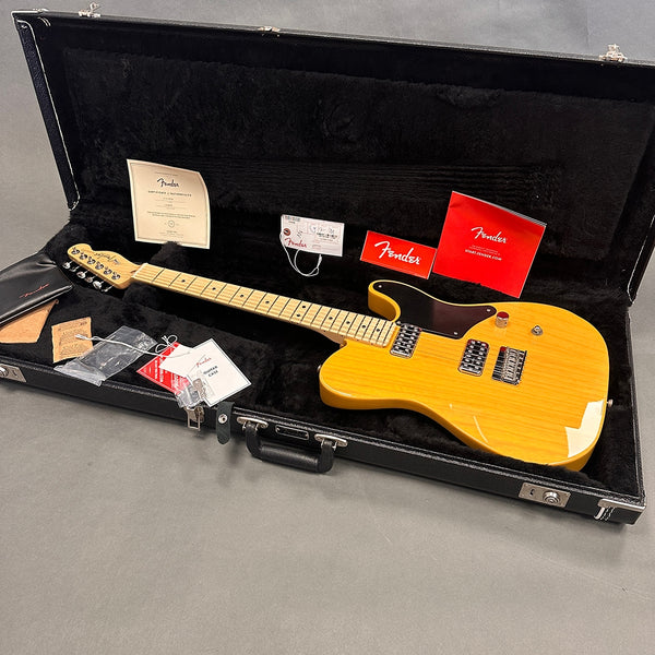 Fender electric guitar with maple neck and black pickguard in black hard case with Fender papers and accessories