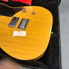 Close-up of yellow electric guitar body with chrome bridge and pickup, black pickguard, and chrome control knob in black plush-lined guitar case