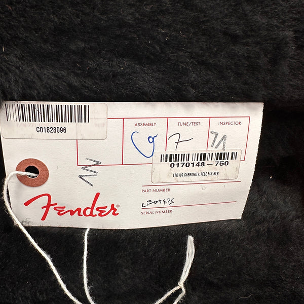 Fender guitar tag with barcode and part number for LTD US Carbonita Tele MH BTB on black fur background