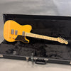 Fender Telecaster electric guitar in natural finish with maple neck and black pickguard inside a black Fender guitar case with plush interior lining.