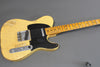 Vintage worn yellow electric guitar with black pickguard and maple neck laid on grey background, Coffee House Guitars product listing