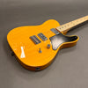 Electric guitar with a bright yellow finish, dual humbucker pickups, black pickguard, single volume knob, and toggle switch on a gray background.