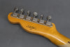Back of Fender Custom Shop guitar headstock with six vintage tuners on gray background