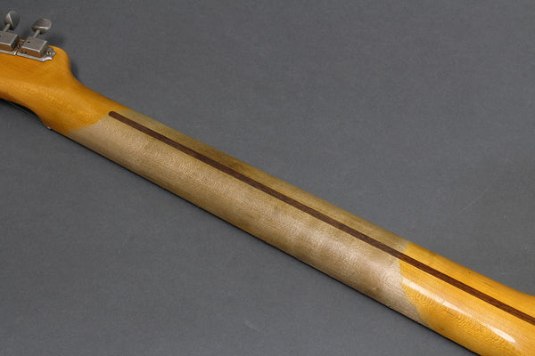 Close-up of guitar neck showing wood grain and lacquer finish with a darker center stripe on gray background