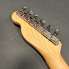 Close-up of maple guitar neck headstock with six chrome tuning pegs on dark gray background