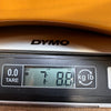 Digital scale showing guitar weight 7 pounds 8.8 ounces on DYMO brand scale at Coffee House Guitars