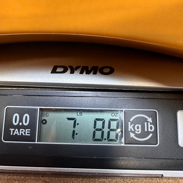 Digital scale showing guitar weight 7 pounds 8.8 ounces on DYMO brand scale at Coffee House Guitars