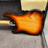Sunburst electric guitar body back in hard case with neck plate and wood grain finish