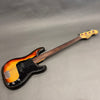 Fender Precision Bass electric bass guitar with sunburst finish and fretless rosewood neck on gray background