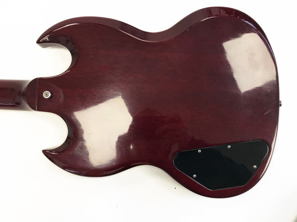 Back of vintage solid body electric guitar with dark reddish-brown finish and black plastic control cavity cover