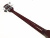 Back view of dark wood bass guitar neck with chrome tuning pegs on white background