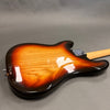 Sunburst finish electric guitar body with visible wood grain and chrome neck plate on gray background