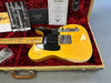 1960s Fender Telecaster electric guitar with maple neck and black pickguard in vintage tweed case with red plush interior, showing Fender certificate and owner's manual