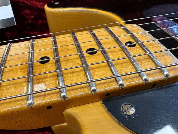 Close-up of vintage electric guitar maple fretboard with worn frets and steel strings on Coffee House Guitars listing