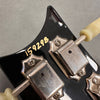 Close-up of vintage guitar tuning pegs and serial number 159298 on black headstock