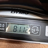 Close-up of Dymo digital scale display showing guitar weight of 8 pounds 11.2 ounces at Coffee House Guitars