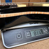Electric guitar body placed on DYMO digital scale showing weight of 8.11 pounds at Coffee House Guitars.