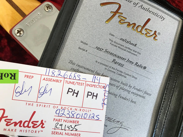 Fender Certificate of Authenticity for 1957 Stratocaster 1my Relic with serial number R91935 and Fender parts tag with serial number R91935, showing detailed handwritten assembly and inspection marks.