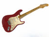 Vintage Fender Stratocaster electric guitar with red body, maple neck, and three single-coil pickups on white background