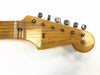 Close-up of vintage Fender Stratocaster guitar headstock with six tuning pegs and strings, natural wood finish with logo and "Original Contour Body" decal