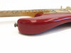Close-up of red electric guitar body with maple neck and white pickups on white background