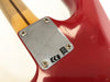 Close-up of red electric guitar neck plate with serial number R91835 and CE certification marking on maple neck with skunk stripe finish