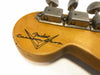 Close-up of vintage Fender Custom Shop guitar headstock with tuning pegs and logo on natural wood finish