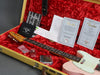 Fender Telecaster Relic electric guitar in pink with white pickguard inside yellow tweed case lined with red plush, showing Fender Custom Care booklet, Certificate of Authenticity, and guitar accessories