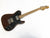 Fender Telecaster Deluxe electric guitar with brown body, black pickguard, maple fretboard, and dual humbucker pickups on white background.