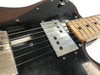 Close-up of electric guitar with black pickguard, silver pickups, maple fretboard, and six strings at Coffee House Guitars product listing