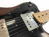 Close-up of vintage electric guitar body with black pickguard, metal humbucker pickup, toggle switch, and maple fretboard.