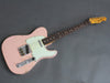 Vintage pink Fender Telecaster electric guitar with rosewood fretboard and aged mint green pickguard on gray background