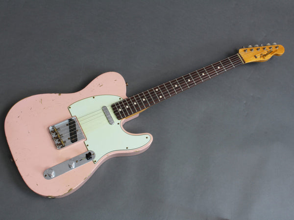 Vintage pink Fender Telecaster electric guitar with rosewood fretboard and aged mint green pickguard on gray background