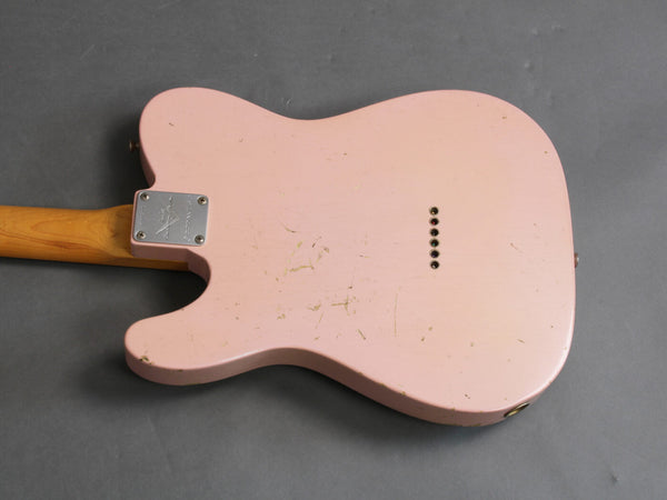 Back view of vintage pink electric guitar body with wood neck and metal neck plate on gray background
