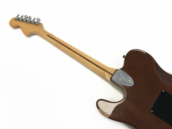 Back view of brown electric guitar with maple neck and chrome tuning pegs isolated on white background