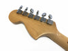 Back of maple guitar headstock with six chrome Fender tuning pegs on white background