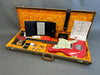 Vintage Fender electric guitar in pink with cream pickguard and P90 pickups in open orange velvet-lined brown hard case with accessories and documentation
