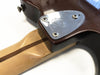 Close-up of Fender electric guitar neck plate with four screws and neck joint showing maple neck with walnut stripe and dark brown body finish on white background