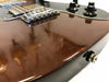Close-up of brown electric guitar body showing finish wear and control knobs at Coffee House Guitars product listing
