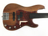 Fretless electric bass guitar with natural wood finish and tortoiseshell pickguard on white background