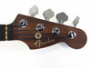 Fender Precision Bass guitar headstock with chrome tuning pegs and dark wood finish on white background