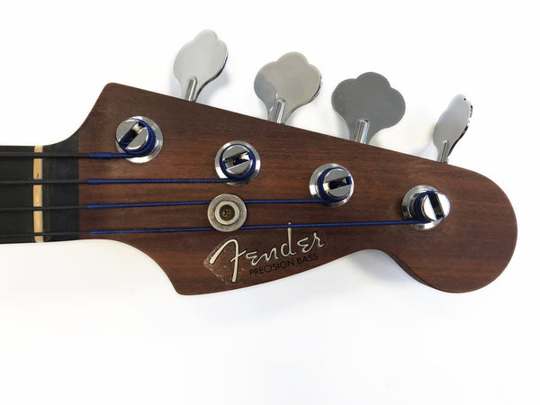 Fender Precision Bass guitar headstock with chrome tuning pegs and dark wood finish on white background