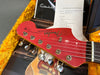 Close-up of red Fender Jazzmaster guitar headstock with tuning pegs and strings, accompanied by a Coffee House Guitars pre-sales checklist and yellow guitar case interior lining