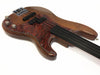 Electric bass guitar with natural wood finish, tortoiseshell pickguard, and fretless black fingerboard on white background