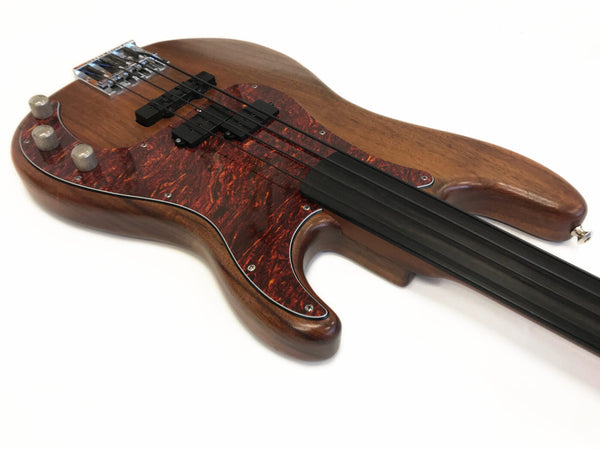 Electric bass guitar with natural wood finish, tortoiseshell pickguard, and fretless black fingerboard on white background