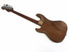 Back view of wooden electric bass guitar with metal tuning pegs and neck plate on white background