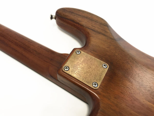 Close-up of wooden guitar neck joint with metal neck plate and screws on Coffee House Guitars electric guitar body