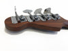 Close-up of chrome tuning pegs on the wooden headstock of a Coffee House Guitars bass guitar against white background